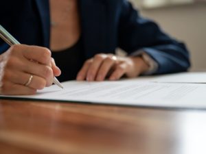 Businesswoman signing a document