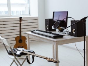 Microphone, computer and musical equipment guitars and piano background