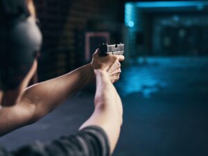 Shooter practicing a two-handed hold at a shooting range