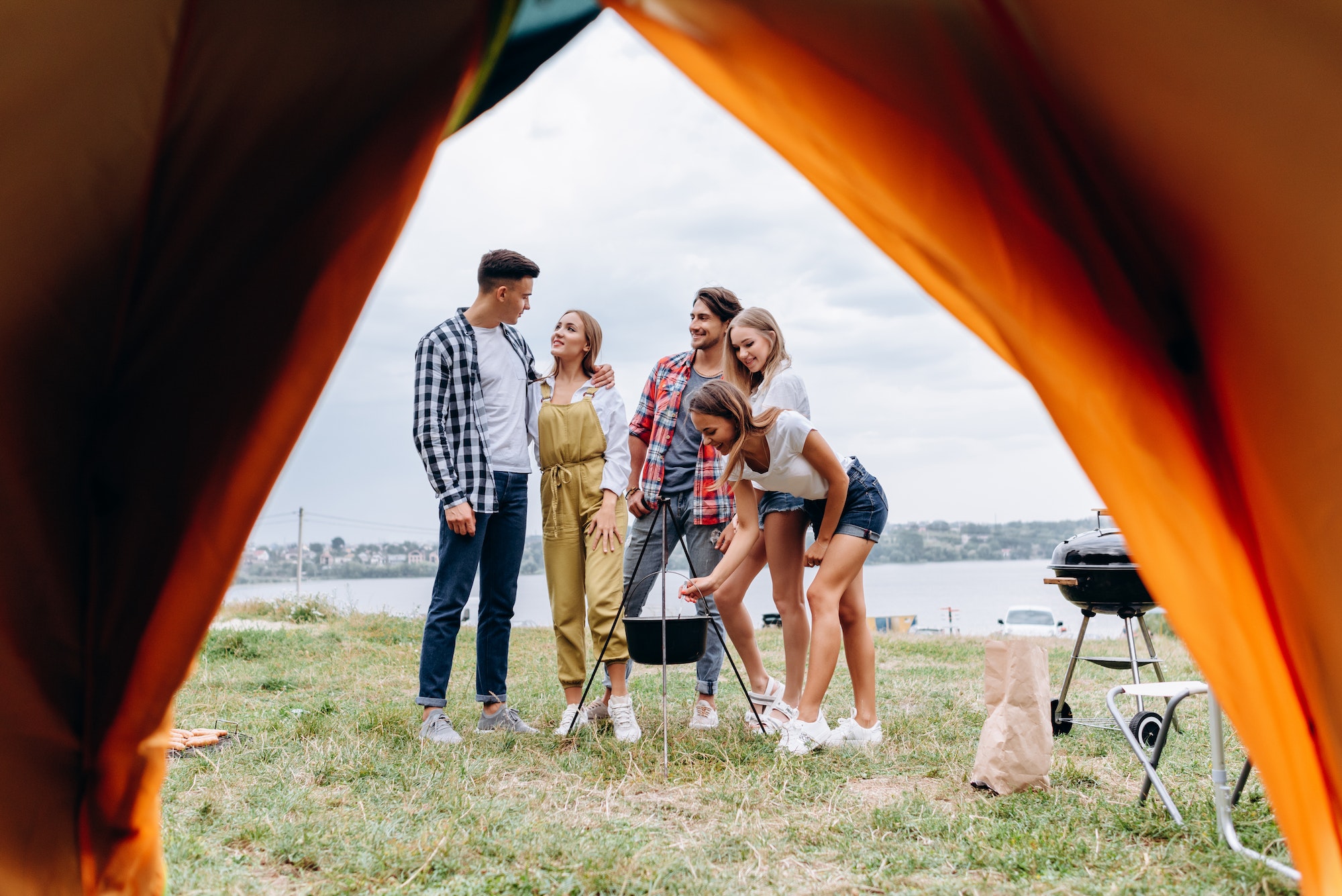 A company of friends have funny time in the camping