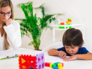 Child psychology, preschooler doing test with didactic cube