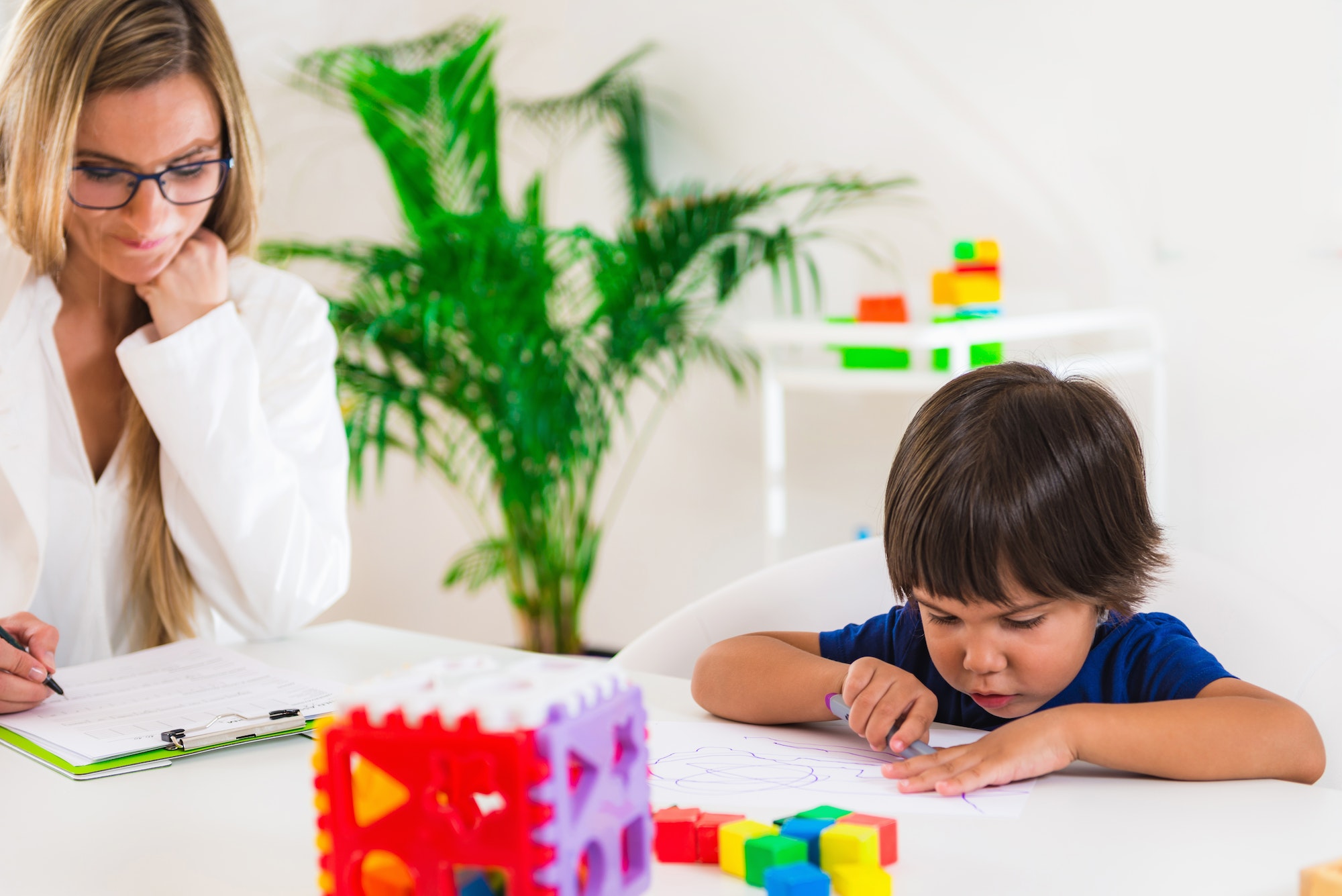 Child psychology, preschooler doing test with didactic cube