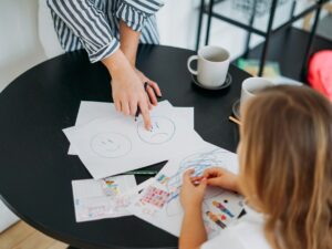 Mother and daughter playing and learning emotions. Children's psychological educational games