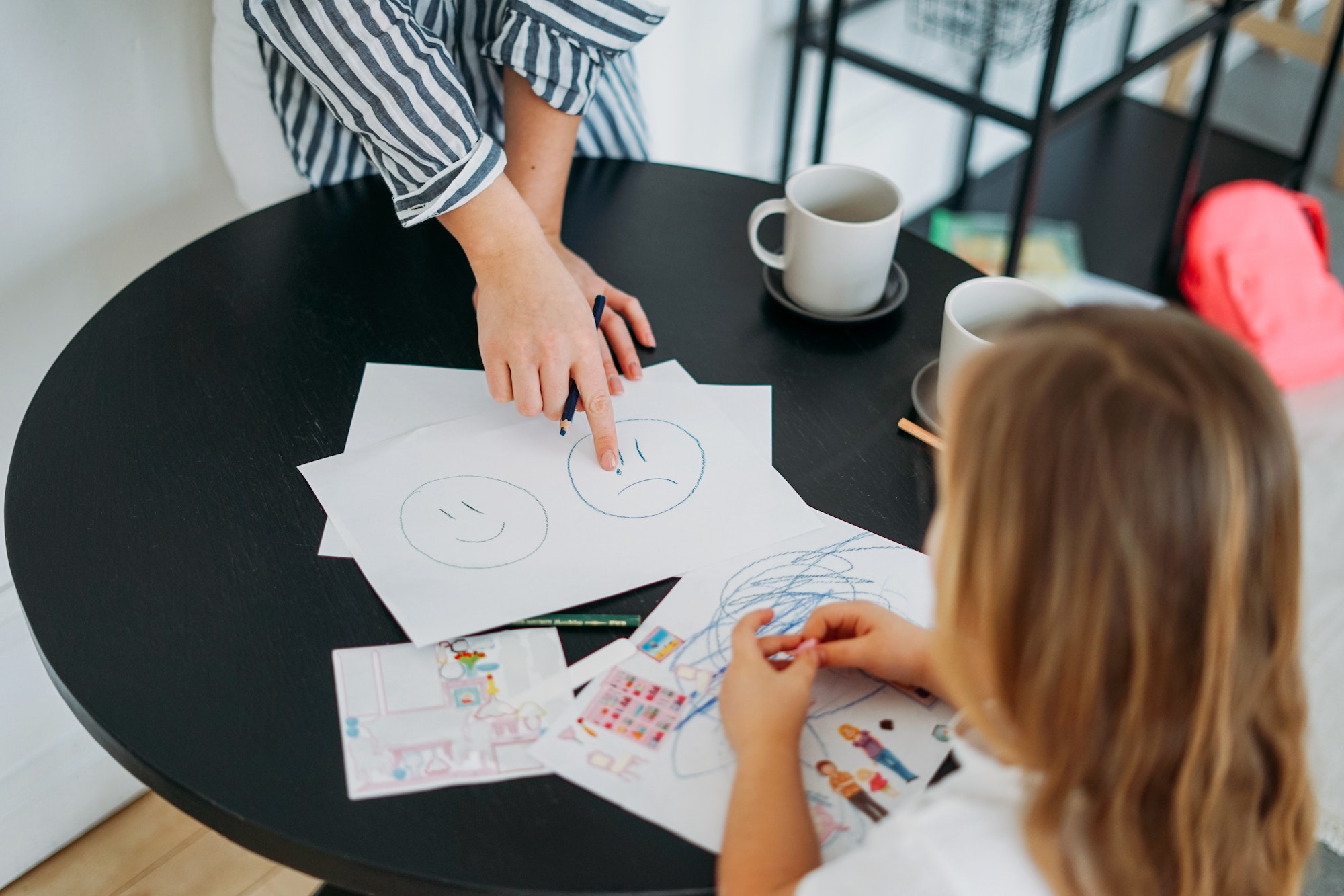 Mother and daughter playing and learning emotions. Children's psychological educational games