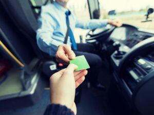 bus driver taking ticket or card from passenger