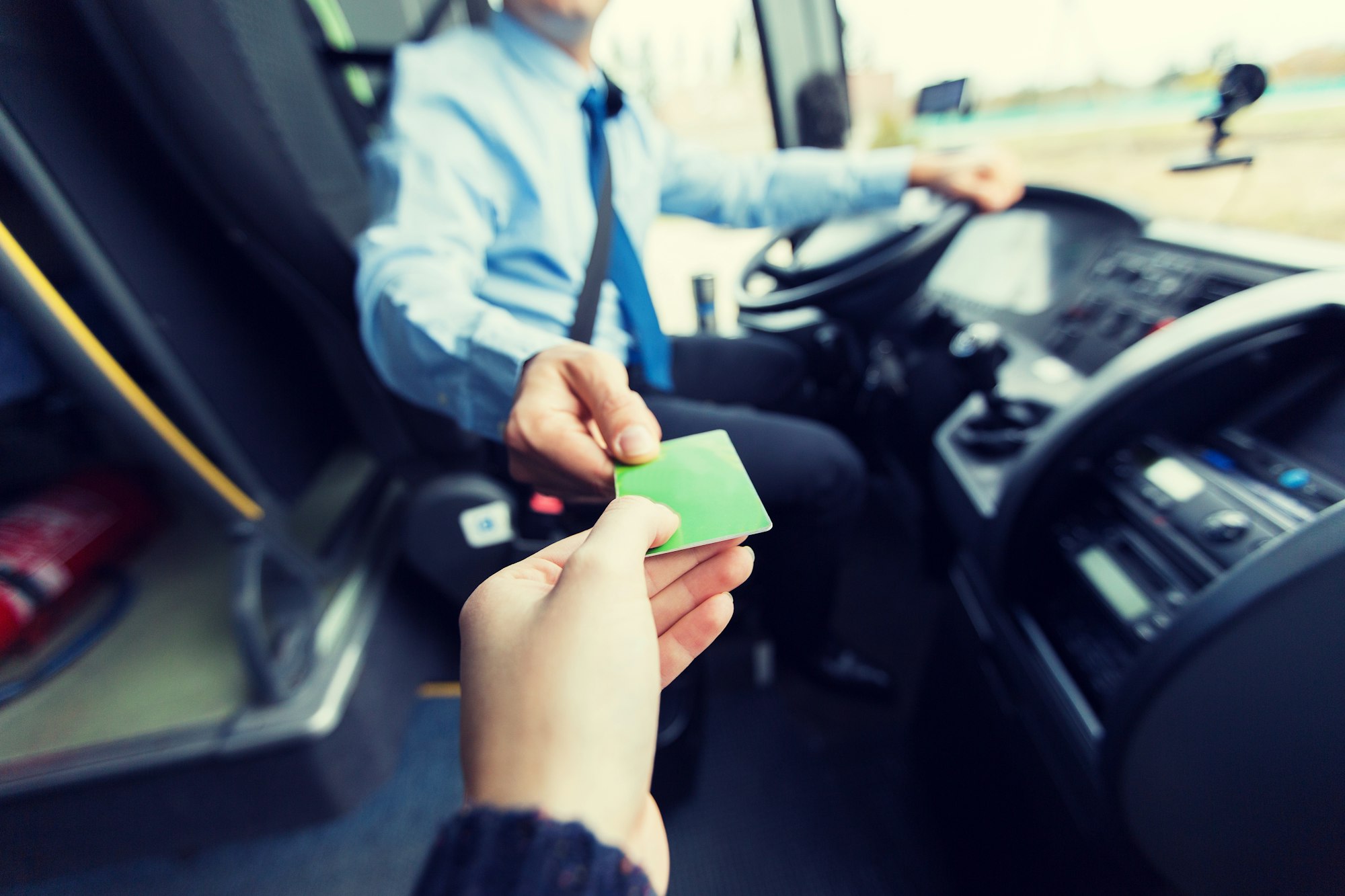 bus driver taking ticket or card from passenger