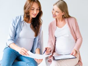 pregnant women talking at prenatal class isolated on white