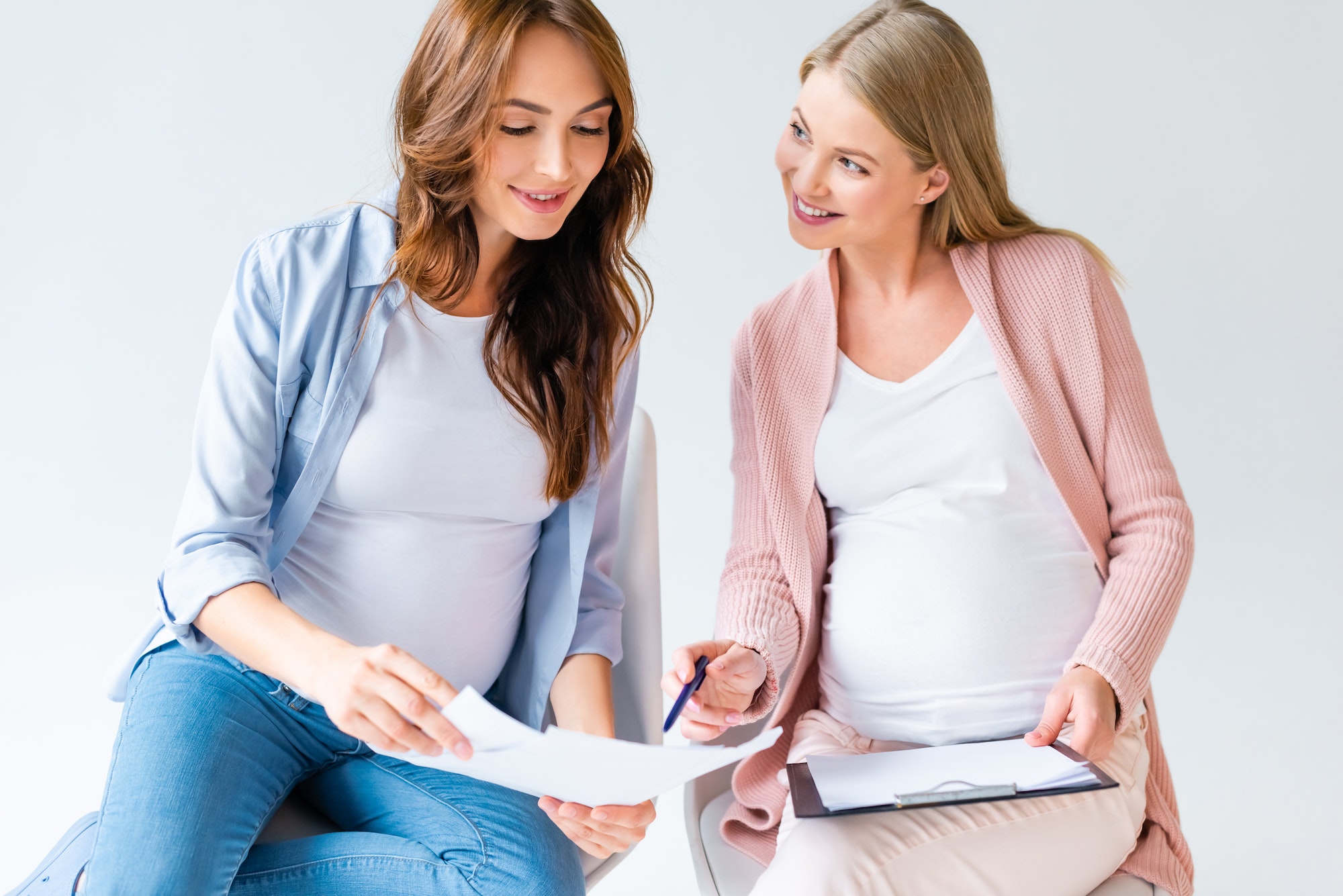 pregnant women talking at prenatal class isolated on white