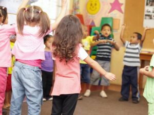 Dancing to get rid of all the energy. Preschool students jumping and dancing around having fun.