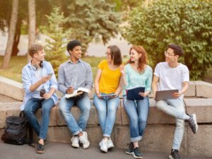 High-School Students Learning Doing Homework Together Sitting Outside