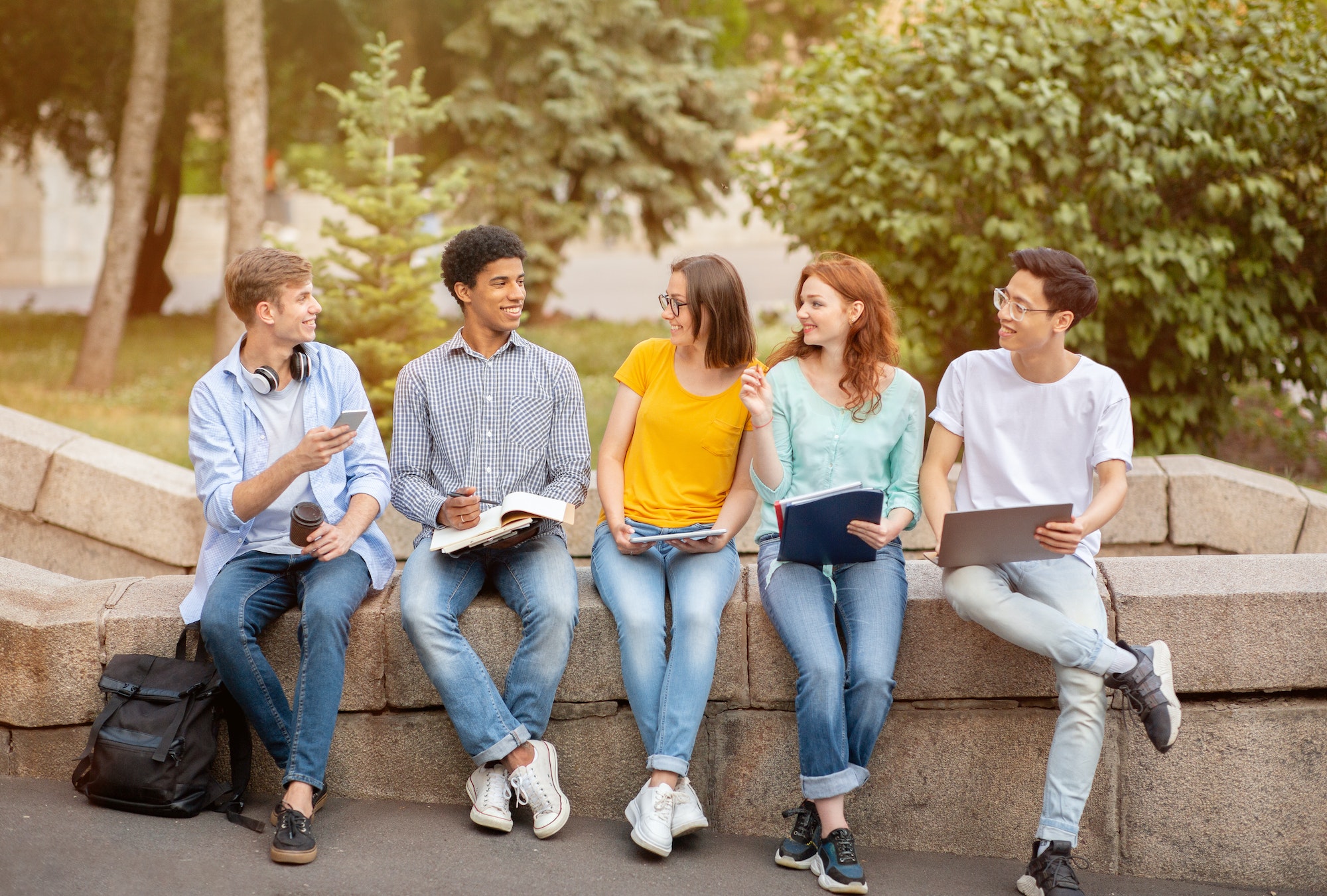 High-School Students Learning Doing Homework Together Sitting Outside