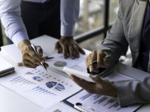 Business executives analyze data documents and calculating about fee tax at an office Image of busin